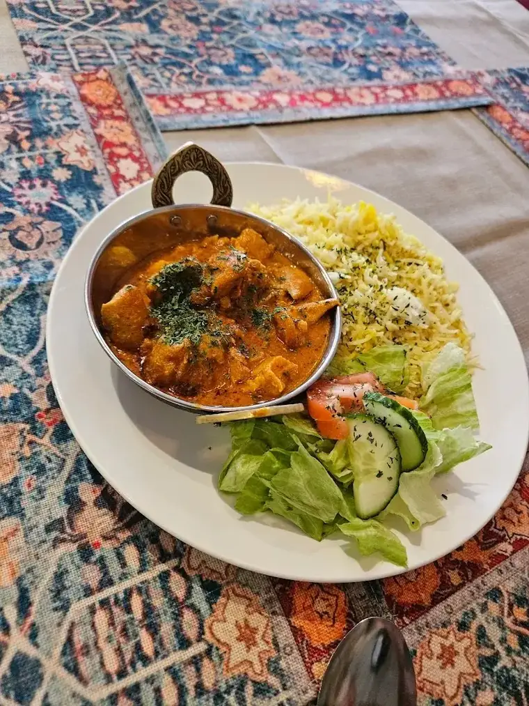Butter chicken with saffron rice and salad at Kaboblicious