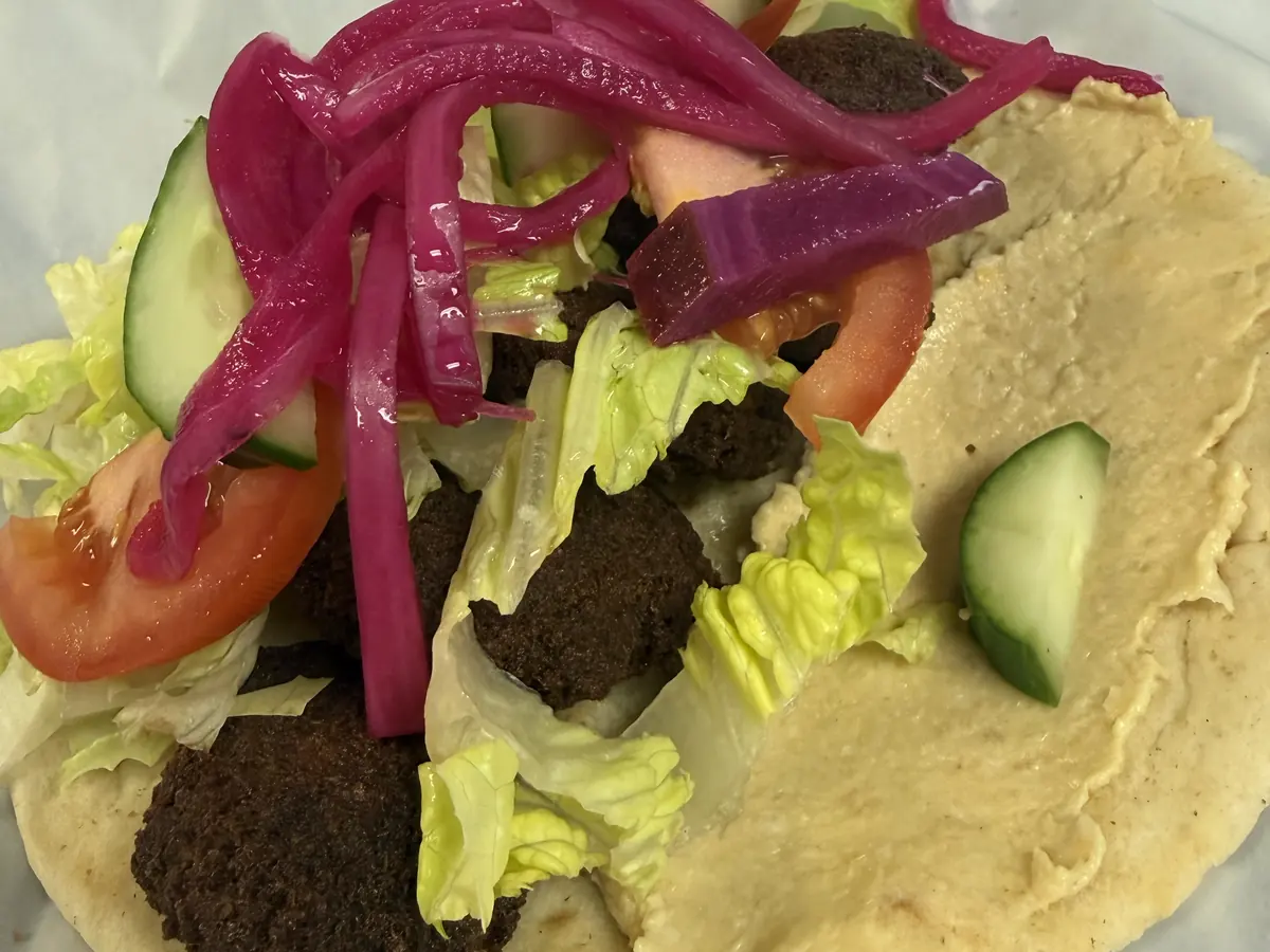 Falafel wrap at Kaboblicious: house-made falafel in warm pita with hummus, lettuce, tomato, cucumber and vinegar onions